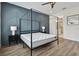 This modern bedroom offers a four-poster bed flanked by matching nightstands and a glimpse into the bright, tiled bathroom at 121 E Warren Ave # 1, Tampa, FL 33602