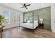 Bedroom features a green accent wall, canopy bed, and abundant natural light at 121 E Warren Ave # 1, Tampa, FL 33602