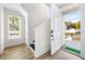 Bright entryway featuring wood flooring, a staircase, and a modern front door leading to a welcoming porch at 121 E Warren Ave # 1, Tampa, FL 33602