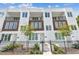 Modern townhome featuring a private front entrance, black metal fence, and minimalist landscaping at 121 E Warren Ave # 1, Tampa, FL 33602