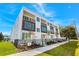 Beautiful modern townhome featuring a white facade, wood accents, and private balconies with black metal railings at 121 E Warren Ave # 1, Tampa, FL 33602