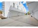 View of the white garage exteriors showcasing multiple units, set against a clear blue sky at 121 E Warren Ave # 1, Tampa, FL 33602