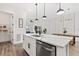 Open-concept kitchen and dining area with a large island, white cabinets, and modern appliances at 121 E Warren Ave # 1, Tampa, FL 33602