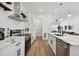 Modern kitchen featuring white cabinets, stainless steel appliances, and a view into the living room at 121 E Warren Ave # 1, Tampa, FL 33602