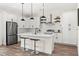 Modern kitchen with white cabinets, stainless steel appliances, a kitchen island, and pendant lighting at 121 E Warren Ave # 1, Tampa, FL 33602