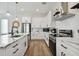 Bright kitchen featuring stainless steel appliances, an island, and pendant lighting at 121 E Warren Ave # 1, Tampa, FL 33602