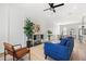 Open-concept living space with contemporary furnishings, a blue sofa, wood floors, and a view of the kitchen at 121 E Warren Ave # 1, Tampa, FL 33602