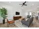 Bright living room with a ceiling fan, a modern sofa, and an open layout design at 121 E Warren Ave # 1, Tampa, FL 33602