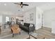 Open-concept living space with a sofa, hardwood floors, and a view of the dining and kitchen areas at 121 E Warren Ave # 1, Tampa, FL 33602