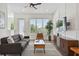 Comfortable living room featuring modern decor, a ceiling fan, and a large window for natural light at 121 E Warren Ave # 1, Tampa, FL 33602