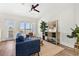 Bright living room with a blue sofa, modern decor, wood floors, and a large window with a view at 121 E Warren Ave # 1, Tampa, FL 33602