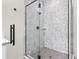 Modern bathroom featuring a glass enclosed shower with eye catching tile at 121 E Warren Ave # 1, Tampa, FL 33602