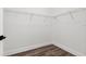 Walk-in closet with wire shelving and wood-look laminate flooring at 121 E Warren Ave # 1, Tampa, FL 33602