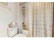 Clean bathroom featuring a toilet and shower featuring a golden patterned shower curtain at 13414 Graham Yarden Dr, Riverview, FL 33579