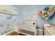 Charming Bedroom with crib, playful sea life decor, and stuffed animal hammock for delightful storage at 13414 Graham Yarden Dr, Riverview, FL 33579