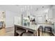 Open-concept dining area with modern light fixtures and a view of the adjacent kitchen area at 13414 Graham Yarden Dr, Riverview, FL 33579