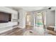 Bright and airy living room with hardwood floors, built-in shelving, and access to the outdoor patio at 13414 Graham Yarden Dr, Riverview, FL 33579