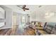Cozy living room with hardwood floors, a ceiling fan, and sliding glass doors to the outdoor patio at 13414 Graham Yarden Dr, Riverview, FL 33579