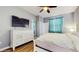 Large main bedroom features a dresser with a TV, ensuite bathroom, and natural light at 13414 Graham Yarden Dr, Riverview, FL 33579