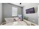 Modern office featuring a large monitor, ergonomic chair and ample natural light at 13414 Graham Yarden Dr, Riverview, FL 33579