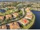 Scenic aerial view of the community featuring lake, golf course and beautiful landscaping at 1348 Emerald Dunes Dr, Sun City Center, FL 33573