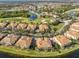 Beautiful aerial view of the community featuring lake, golf course and pool at 1348 Emerald Dunes Dr, Sun City Center, FL 33573