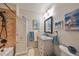 Stylish bathroom featuring granite countertops, a shower with decorative tile, and ample storage at 1348 Emerald Dunes Dr, Sun City Center, FL 33573