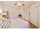 Well-lit bedroom with a ceiling fan, closet, and view to the ensuite bath at 1348 Emerald Dunes Dr, Sun City Center, FL 33573