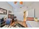 Well-lit bedroom featuring a ceiling fan, closet, and view to the ensuite bath at 1348 Emerald Dunes Dr, Sun City Center, FL 33573