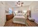 Bright bedroom with wood floors, a ceiling fan, and natural light from the window at 1348 Emerald Dunes Dr, Sun City Center, FL 33573