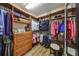 Spacious walk-in closet with custom shelves, drawers, and ample storage space for clothes at 1348 Emerald Dunes Dr, Sun City Center, FL 33573