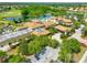 Aerial view of the Clubhouse featuring the pool, parking, and beautifully landscaped property at 1348 Emerald Dunes Dr, Sun City Center, FL 33573