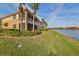 Two-story home featuring a screened in porch, balcony, and water view at 1348 Emerald Dunes Dr, Sun City Center, FL 33573