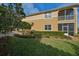 Charming two-story home featuring manicured landscaping and lush green grass at 1348 Emerald Dunes Dr, Sun City Center, FL 33573