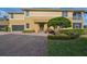 Inviting two-story home with well-maintained landscaping, a charming entrance, and a brick driveway at 1348 Emerald Dunes Dr, Sun City Center, FL 33573