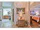 Inviting hallway featuring tile flooring and elegant decor leading to bedroom and bathroom at 1348 Emerald Dunes Dr, Sun City Center, FL 33573