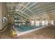 Bright and spacious indoor pool area with tiled deck and well lit with flags at 1348 Emerald Dunes Dr, Sun City Center, FL 33573