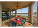 Cozy screened lanai with ceiling fans, tile flooring, and a lovely view of the water at 1348 Emerald Dunes Dr, Sun City Center, FL 33573