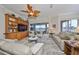 Bright living room with comfortable seating, custom built-ins, and serene water views from large sliding glass doors at 1348 Emerald Dunes Dr, Sun City Center, FL 33573