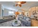 Bright living room flows into the kitchen and dining areas, featuring comfortable seating and an open layout at 1348 Emerald Dunes Dr, Sun City Center, FL 33573