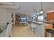 Open-concept living area with kitchen island, dining area, and views of the lake at 1348 Emerald Dunes Dr, Sun City Center, FL 33573
