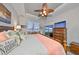 Serene main bedroom boasts a ceiling fan, scenic water view, and direct access to an outdoor patio at 1348 Emerald Dunes Dr, Sun City Center, FL 33573