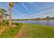 Scenic view of a tranquil lake surrounded by lush greenery and beautiful homes at 1348 Emerald Dunes Dr, Sun City Center, FL 33573