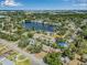 Beautiful aerial view featuring a tranquil lake, verdant trees, and the surrounding neighborhood at 1404 84Th N Ave, St Petersburg, FL 33702