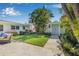 The landscaped backyard provides a private oasis with a patio, lush greenery, and access to a detached structure at 1404 84Th N Ave, St Petersburg, FL 33702