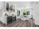 Dining area with a wine fridge, stylish cabinets, and an adjacent dining table at 1404 84Th N Ave, St Petersburg, FL 33702