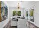 Elegant dining room featuring a round table, white chairs, and sliding doors to the pool at 1404 84Th N Ave, St Petersburg, FL 33702