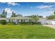 Charming single-story home with lush green lawn, manicured hedges, and a well-maintained front yard at 1404 84Th N Ave, St Petersburg, FL 33702