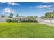 Charming single-story home with lush green lawn, manicured hedges, and a well-maintained front yard at 1404 84Th N Ave, St Petersburg, FL 33702