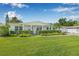 Charming single-story home with lush green lawn, manicured hedges, and a well-maintained front yard at 1404 84Th N Ave, St Petersburg, FL 33702